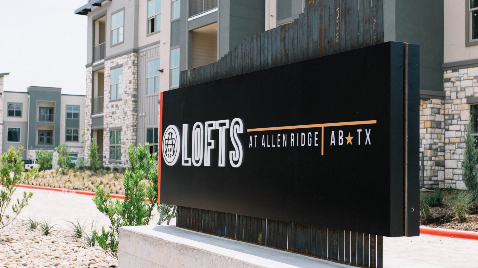 the sign for the apartments at The Lofts at Allen Ridge