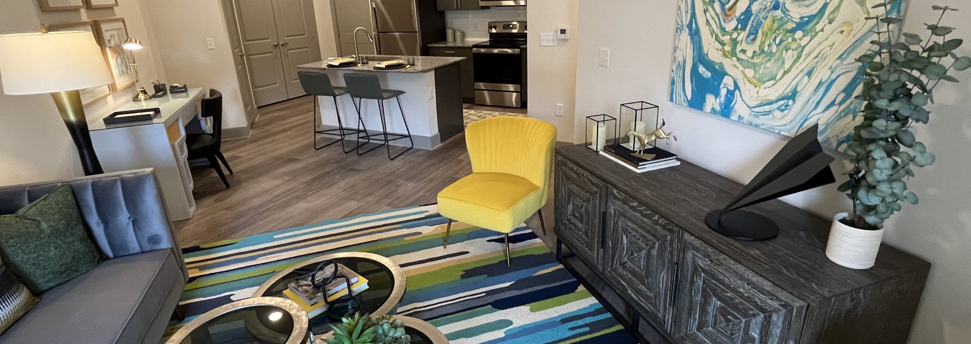 a living room with a blue and yellow rug at The Lofts at Allen Ridge