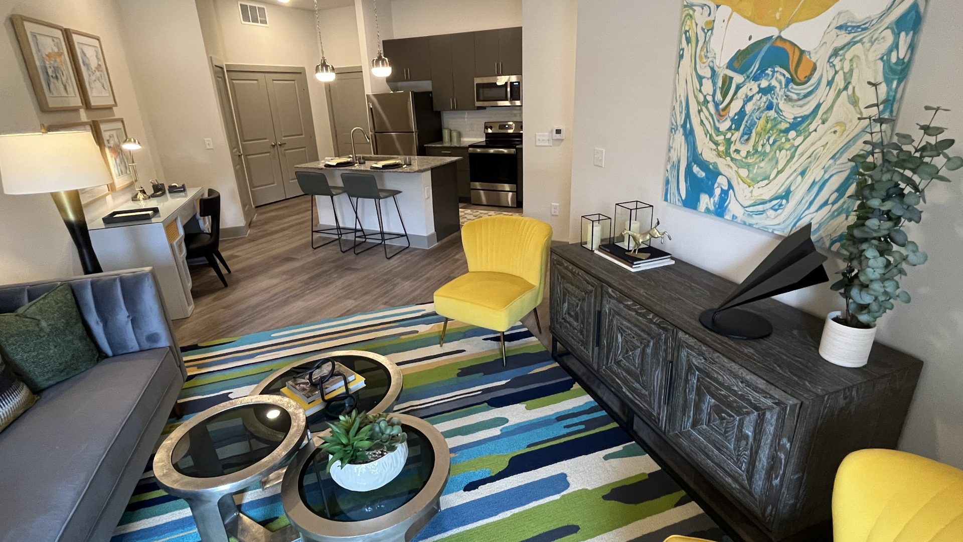 a living room with a blue and yellow rug at The Lofts at Allen Ridge