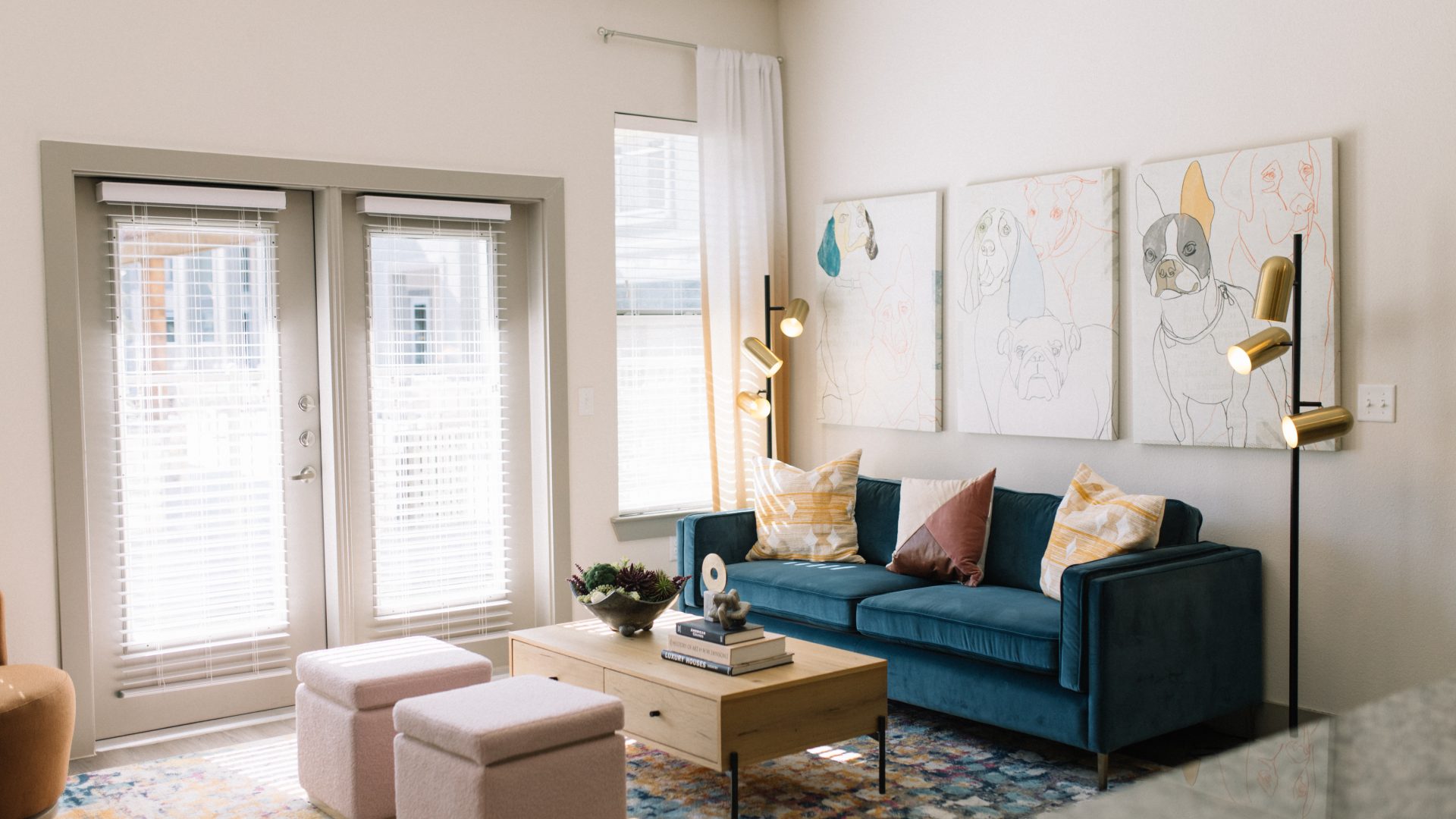 a living room with blue couches and a coffee table at The Lofts at Allen Ridge