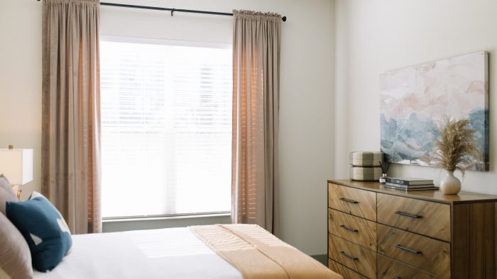 a bedroom with a bed, dresser and nightstand at The Lofts at Allen Ridge