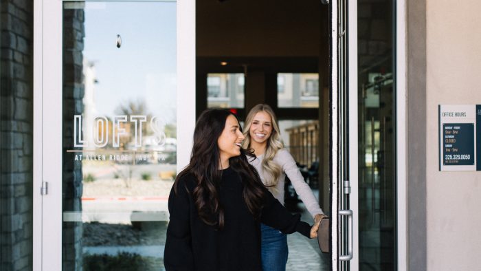 two women standing in front of a door at The Lofts at Allen Ridge